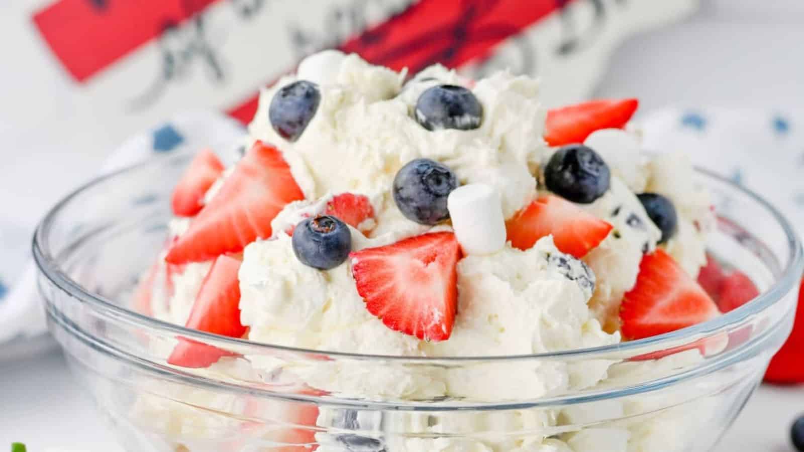 Cheesecake salad mixed with berries and creamy filling in patriotic colors.