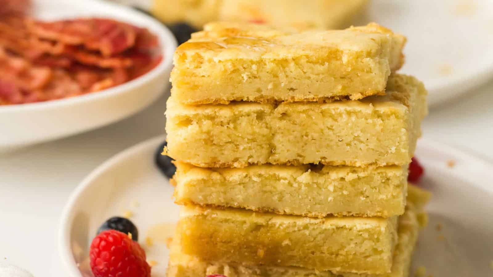 Sheet pan pancakes baked fluffy and sliced into squares for serving.