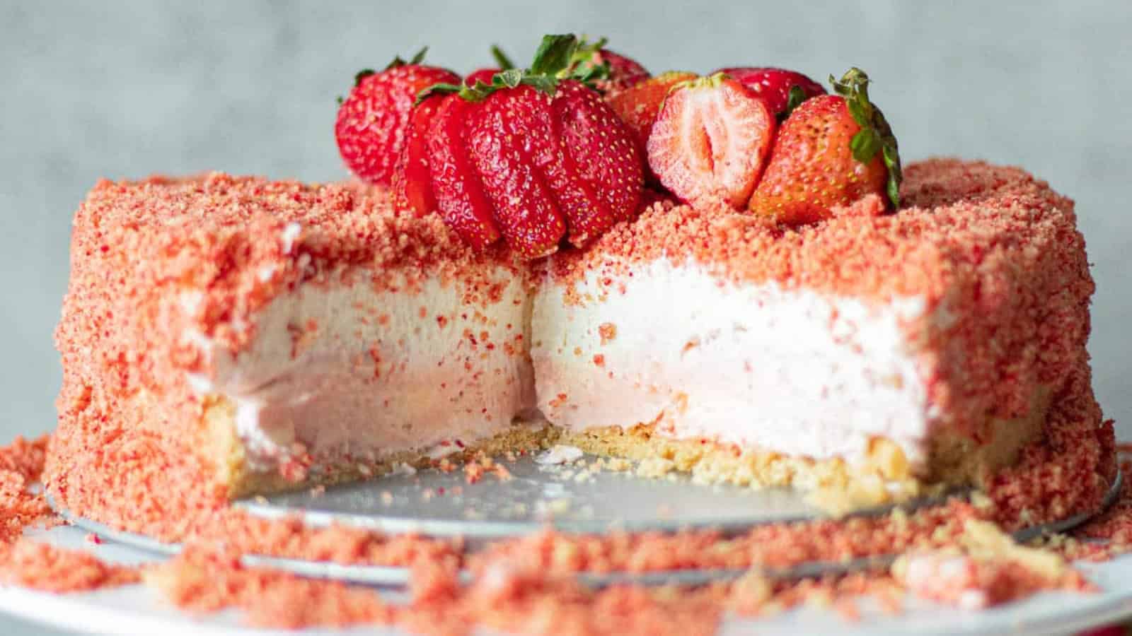 Cheesecake topped with strawberry crunch coating and creamy filling.