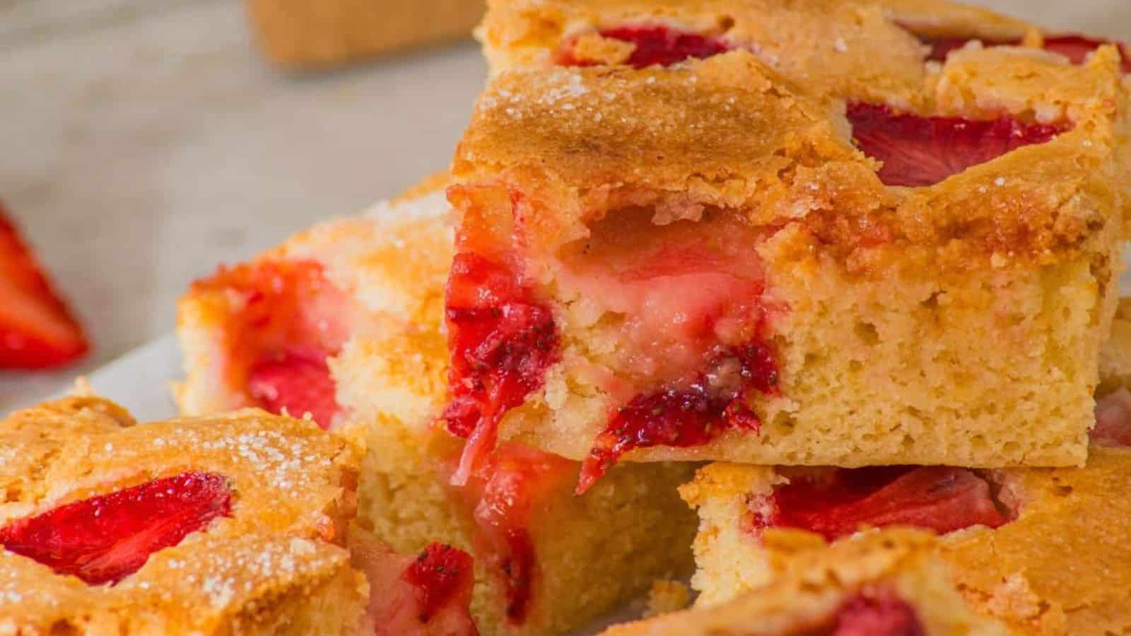 Strawberry sheet cake baked moist with pink frosting and fresh berry flavor.