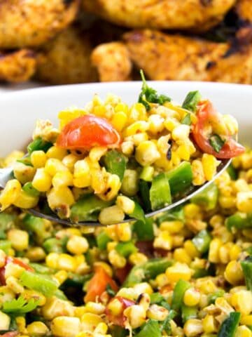 Corn salad mixed with creamy dressing and Mexican-style seasoning.