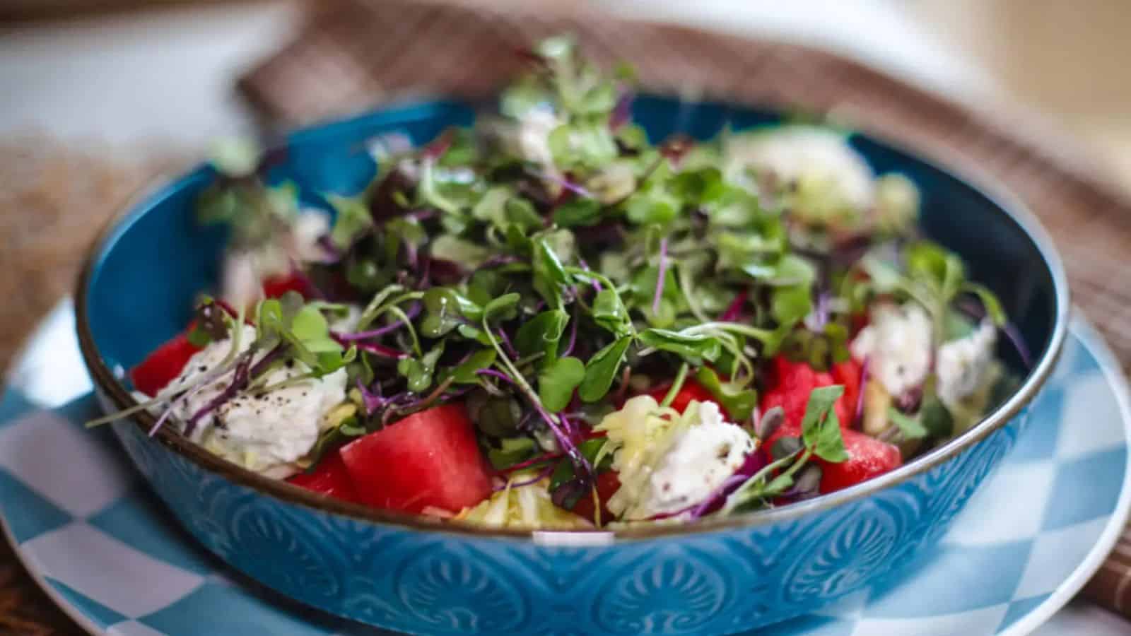 Watermelon salad tossed with crunchy ingredients and a sweet spicy dressing.