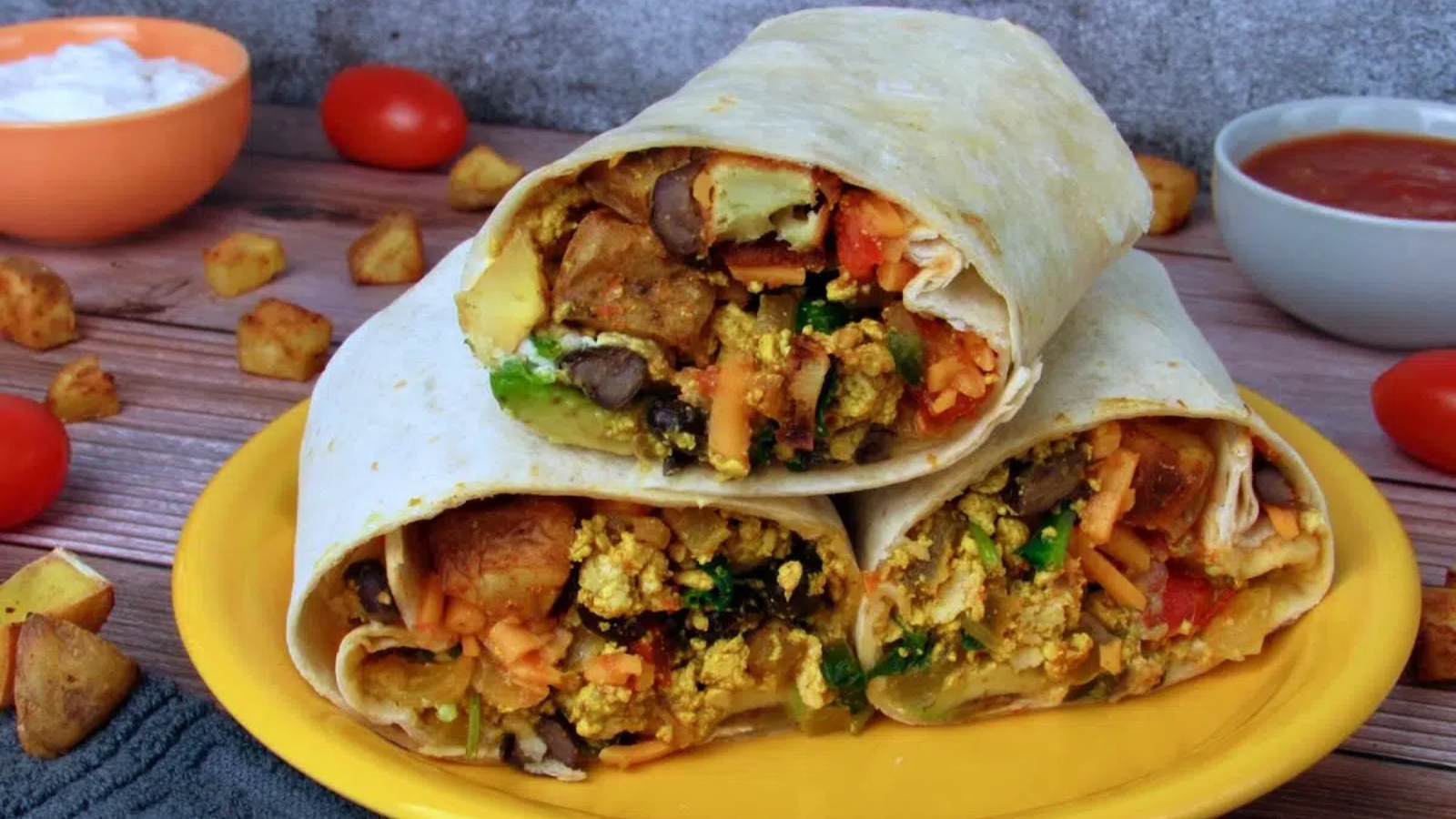 Vegan breakfast burrito filled with Tex Mex ingredients and vegetables.