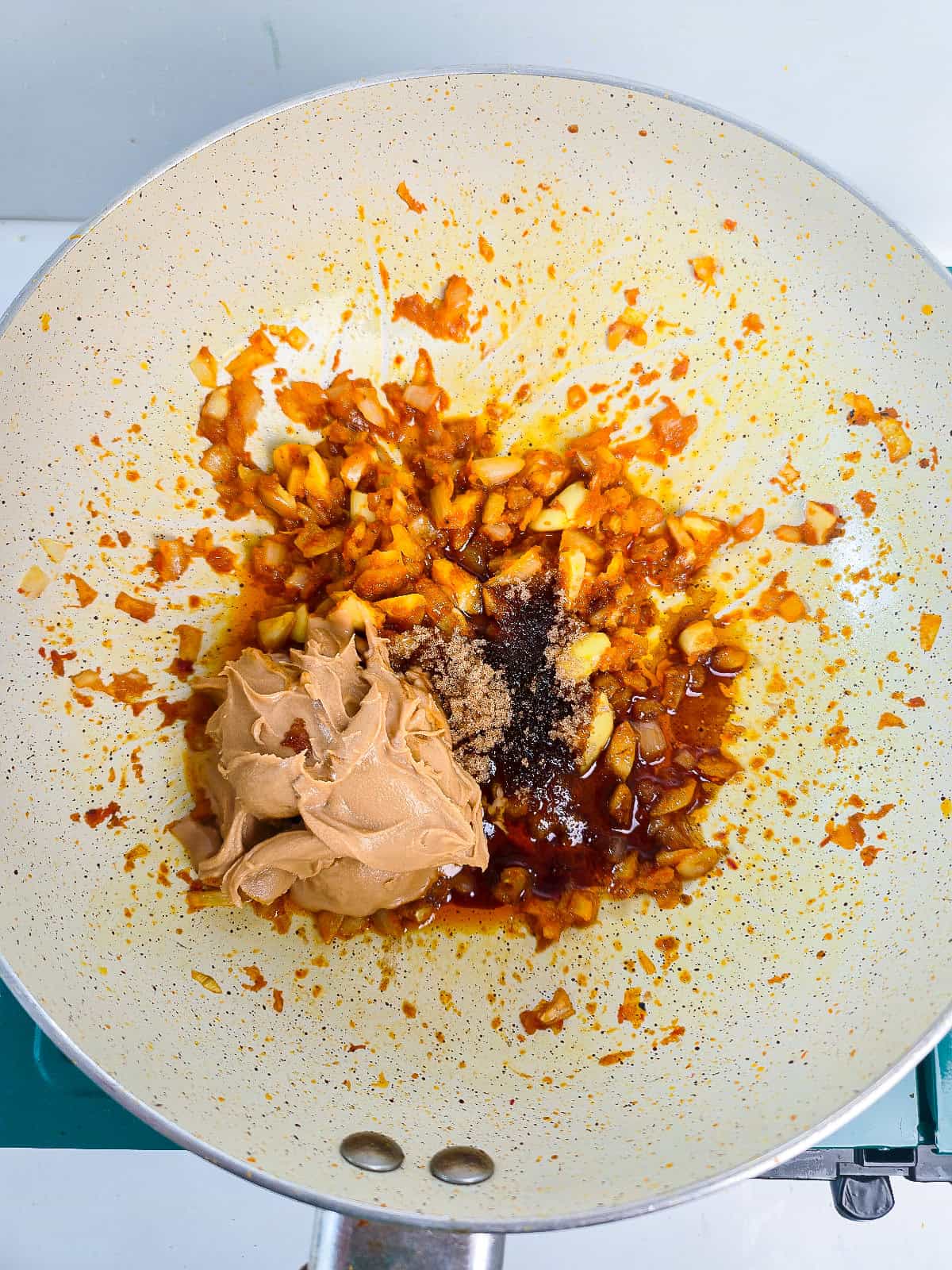 Peanut butter, soy sauce, and seasonings added to the skillet for creamy satay sauce.