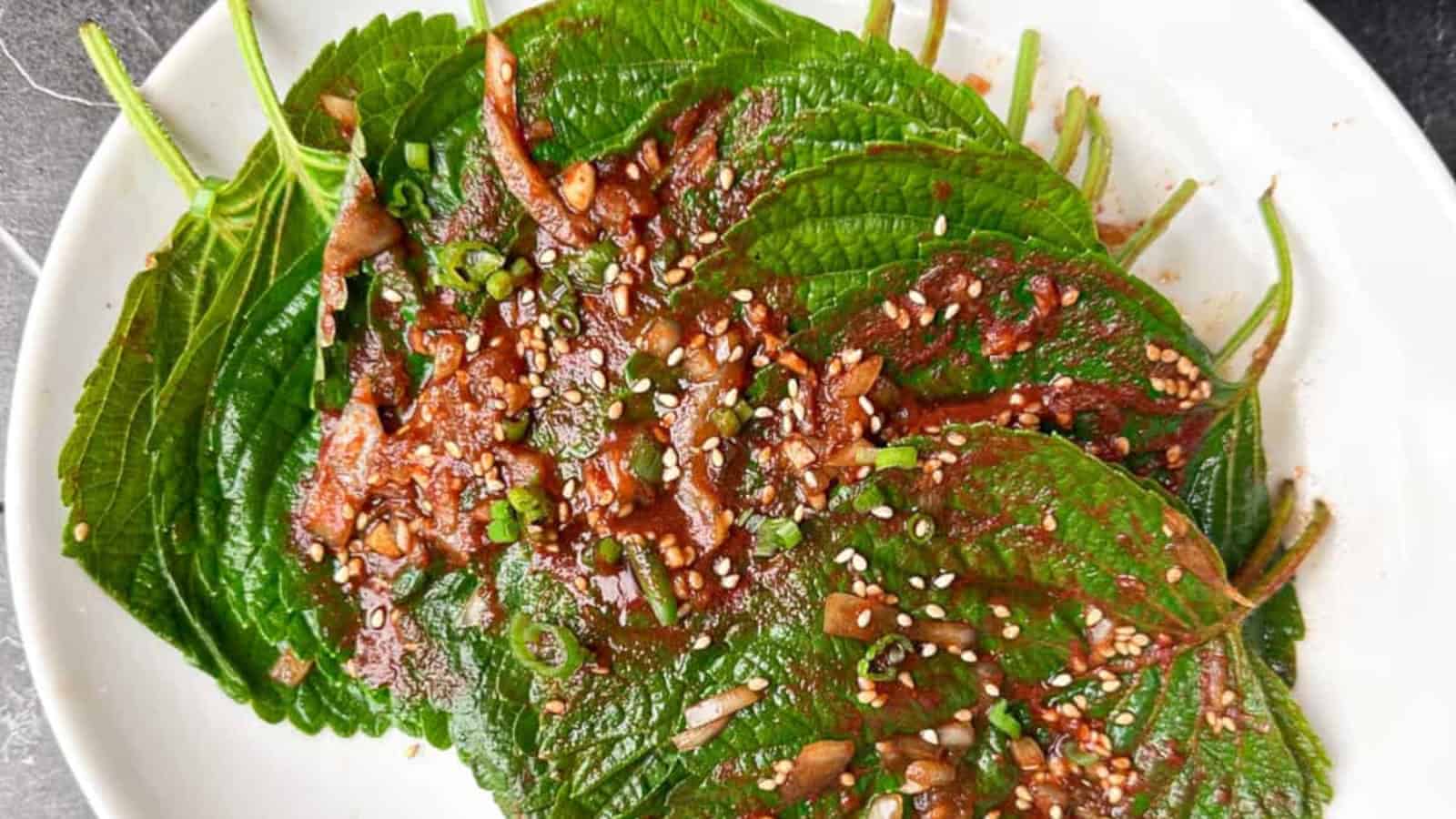 Flavorful Korean perilla leaf kimchi on a white plate.