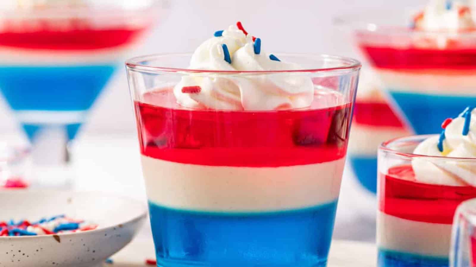 Layered red, white, and blue gelatin cups with patriotic colors.