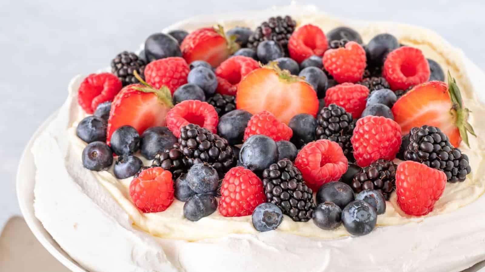 Crisp pavlova topped with whipped cream and fresh berries.