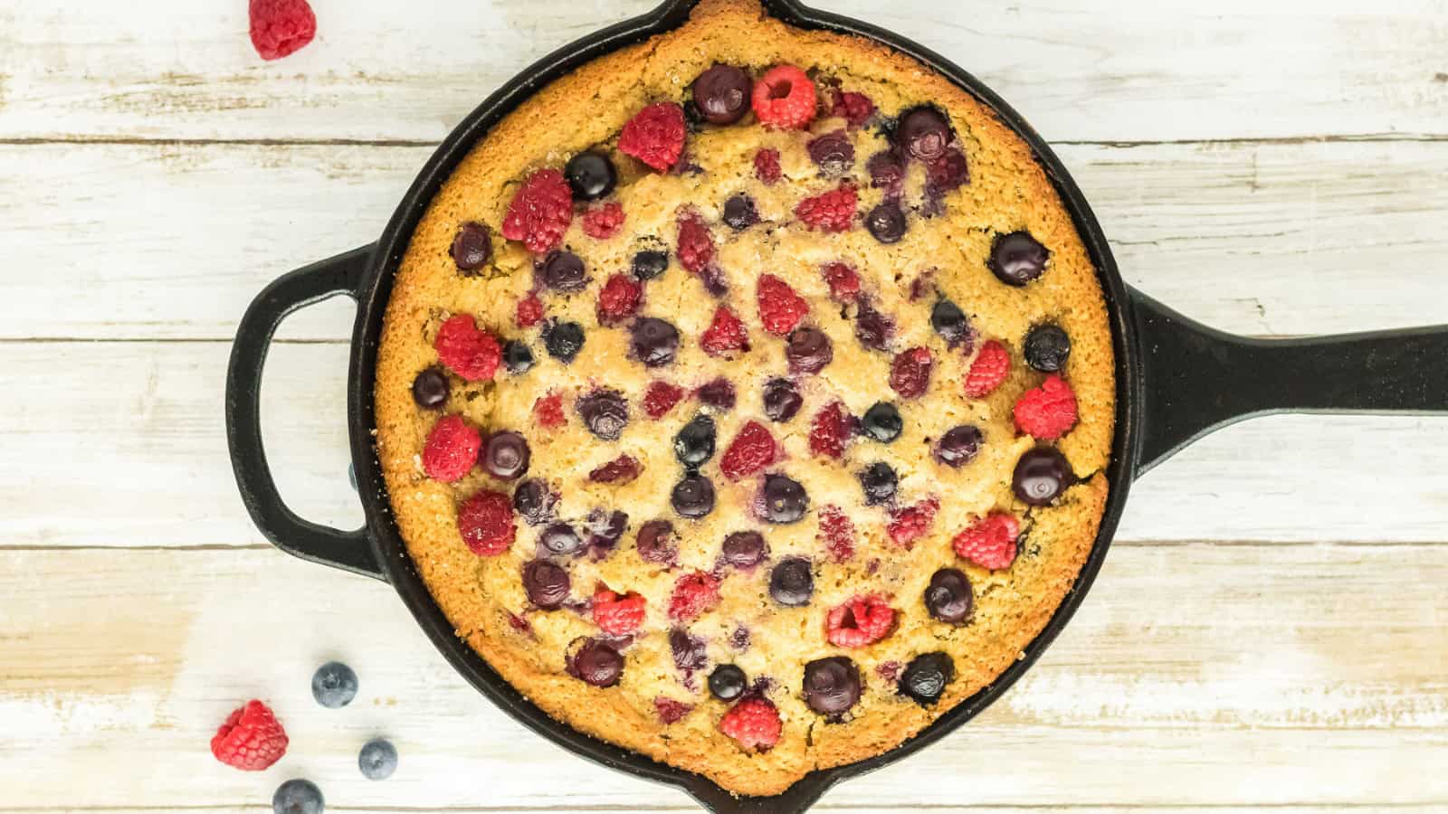 Skillet cake baked with berries and a rich brown sugar topping.