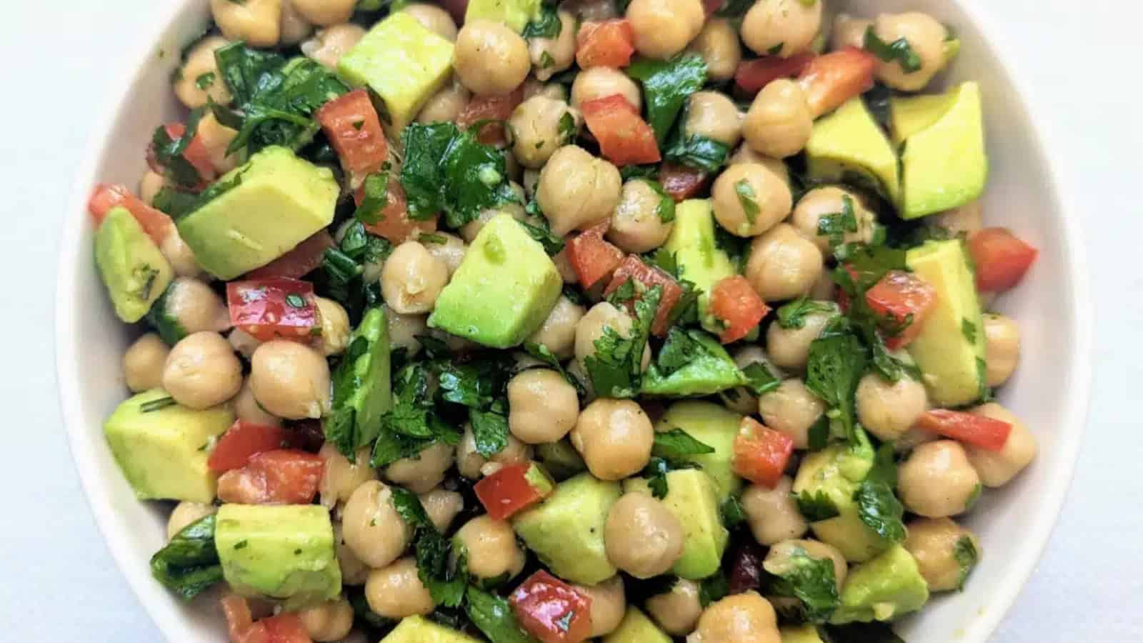 Chickpea avocado salad with fresh vegetables and a light citrus dressing.