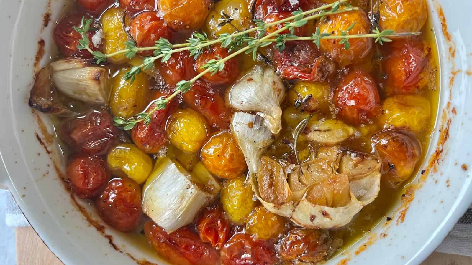 Cherry tomatoes and garlic slowly cooked in oil until tender.