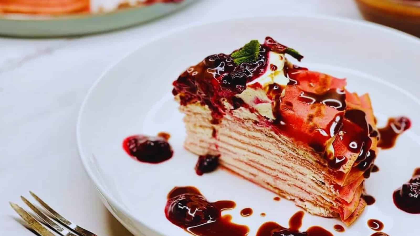 Crepes cake layered with cream and fresh mixed berries.