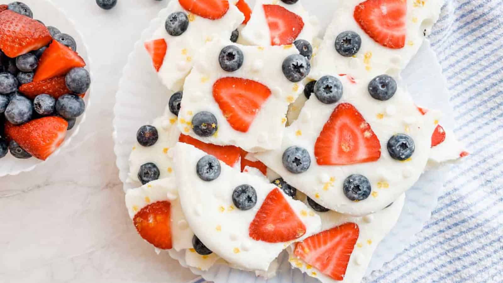 Frozen yogurt bark topped with fresh berries and crunchy toppings.