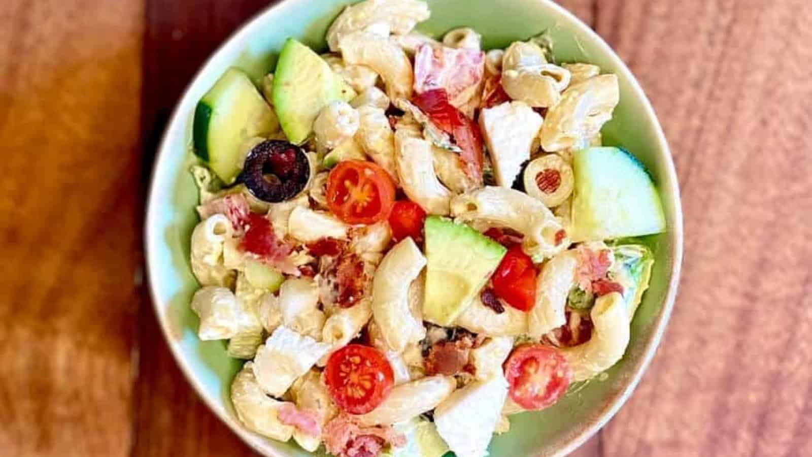Loaded macaroni salad packed with vegetables, cheese, and creamy dressing.
