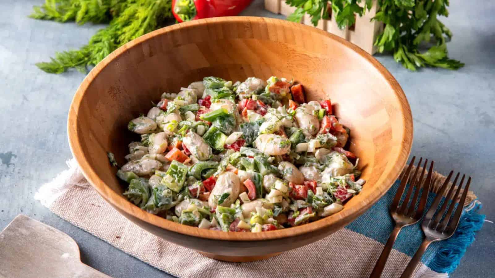 Mediterranean bean salad packed with colorful vegetables and herbs.
