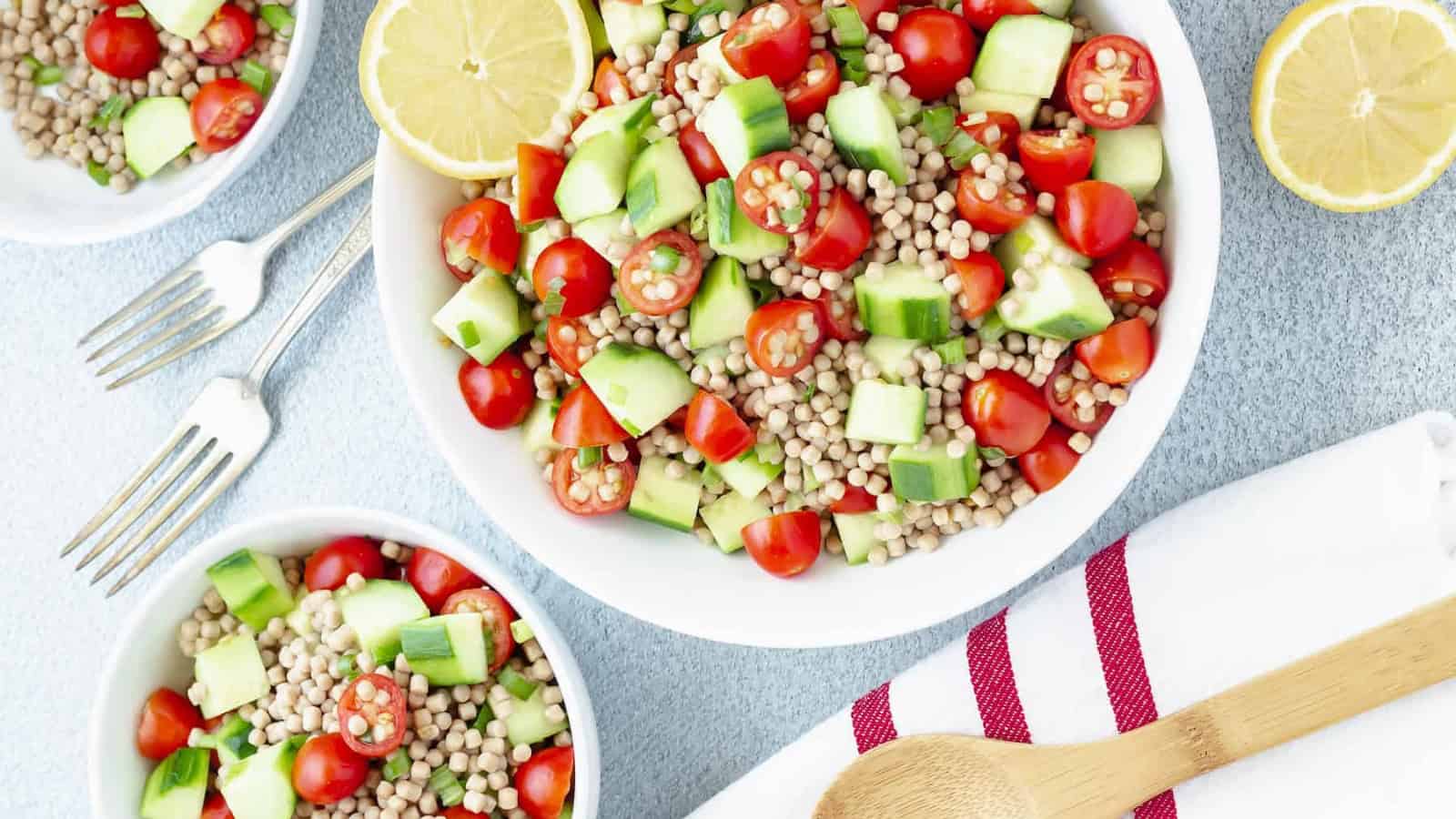 Mediterranean couscous salad with cucumbers, tomatoes, and fresh herbs.