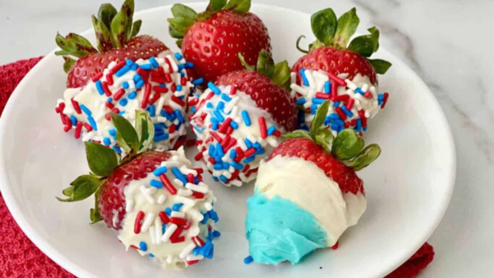 Strawberries dipped and decorated with red, white, and blue coatings.