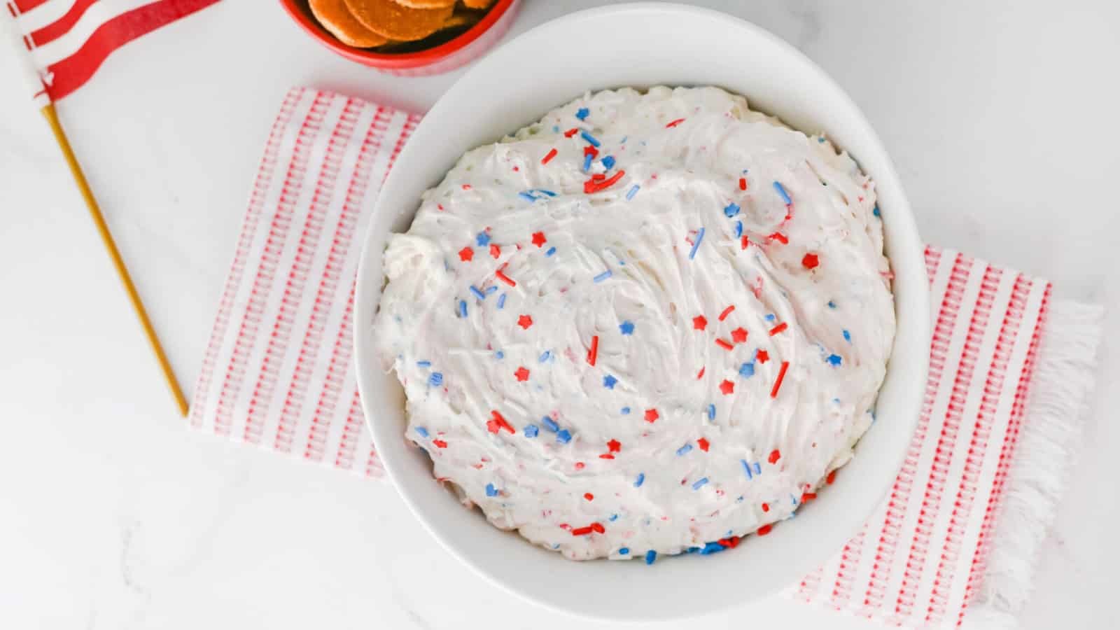 Creamy Funfetti dip topped with festive red, white, and blue sprinkles.
