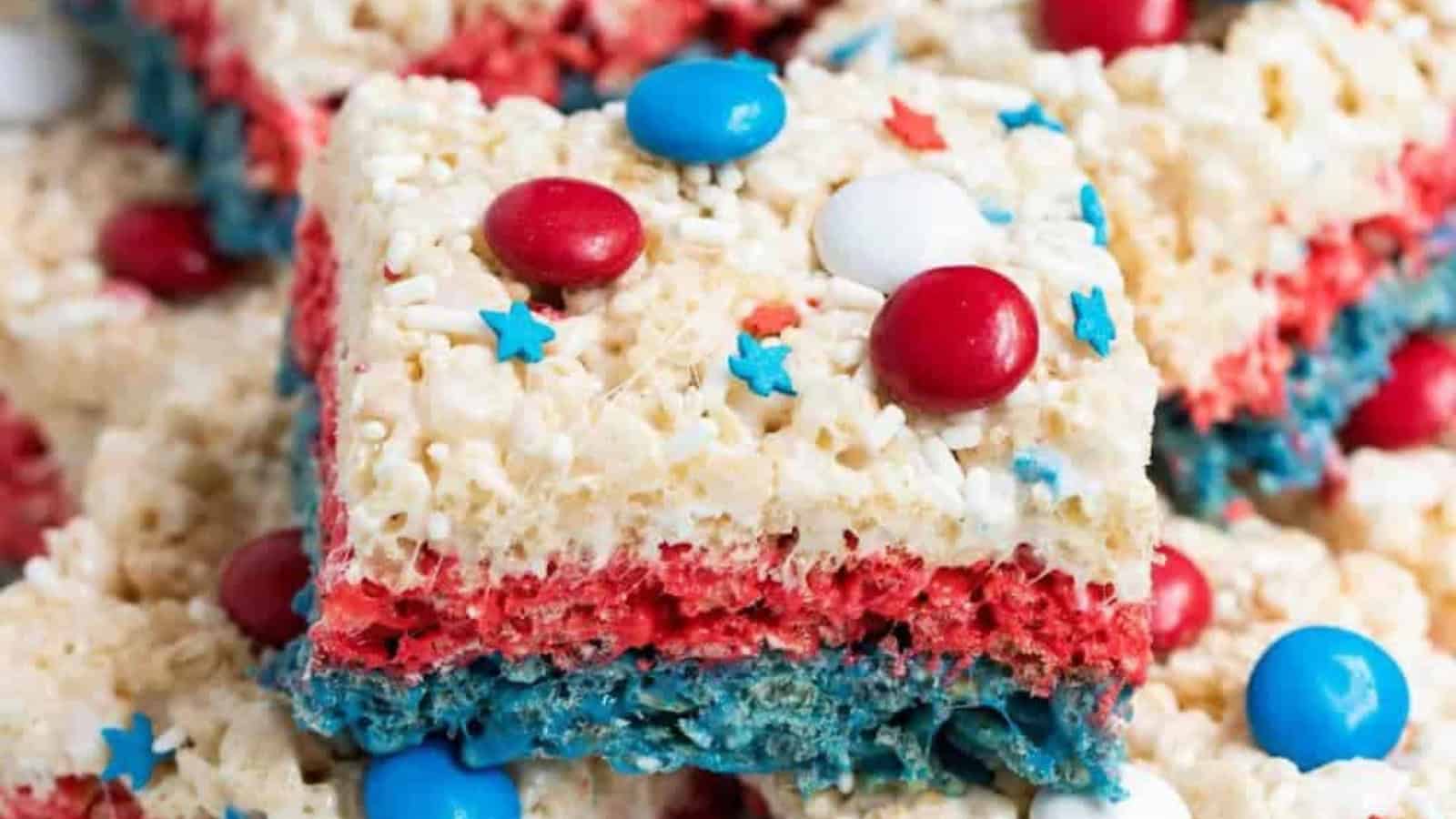 Rice Krispie treats decorated with patriotic colors and sprinkles.