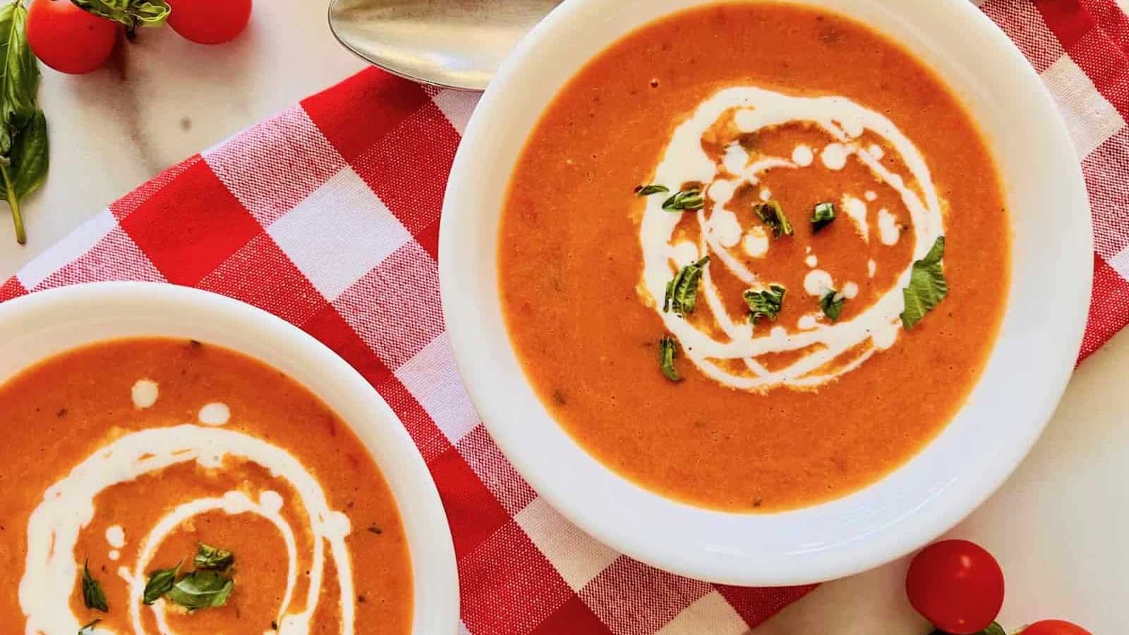 Roasted cherry tomato soup served smooth and garnished with herbs.