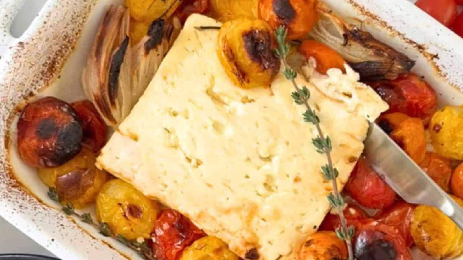 Baked feta dip topped with roasted tomatoes and fresh herbs.