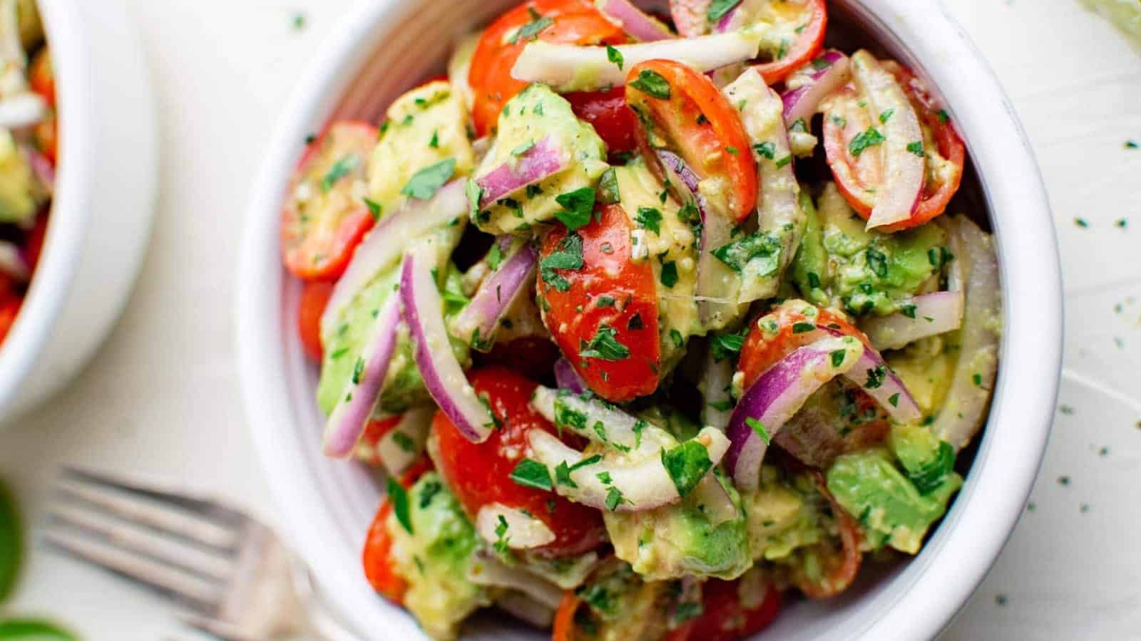 Tomato avocado salad with fresh herbs and a simple vinaigrette.