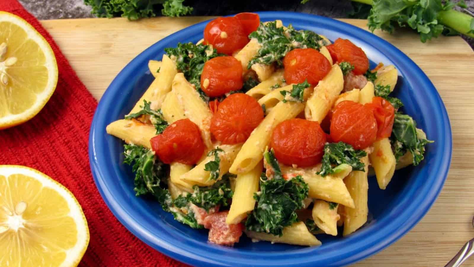 Vegan pasta with tomato ricotta sauce, kale, and cherry tomatoes.