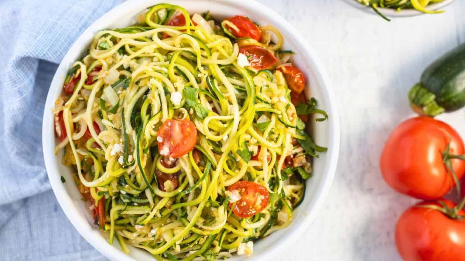 Zucchini noodles tossed with cherry tomatoes and fresh herbs.