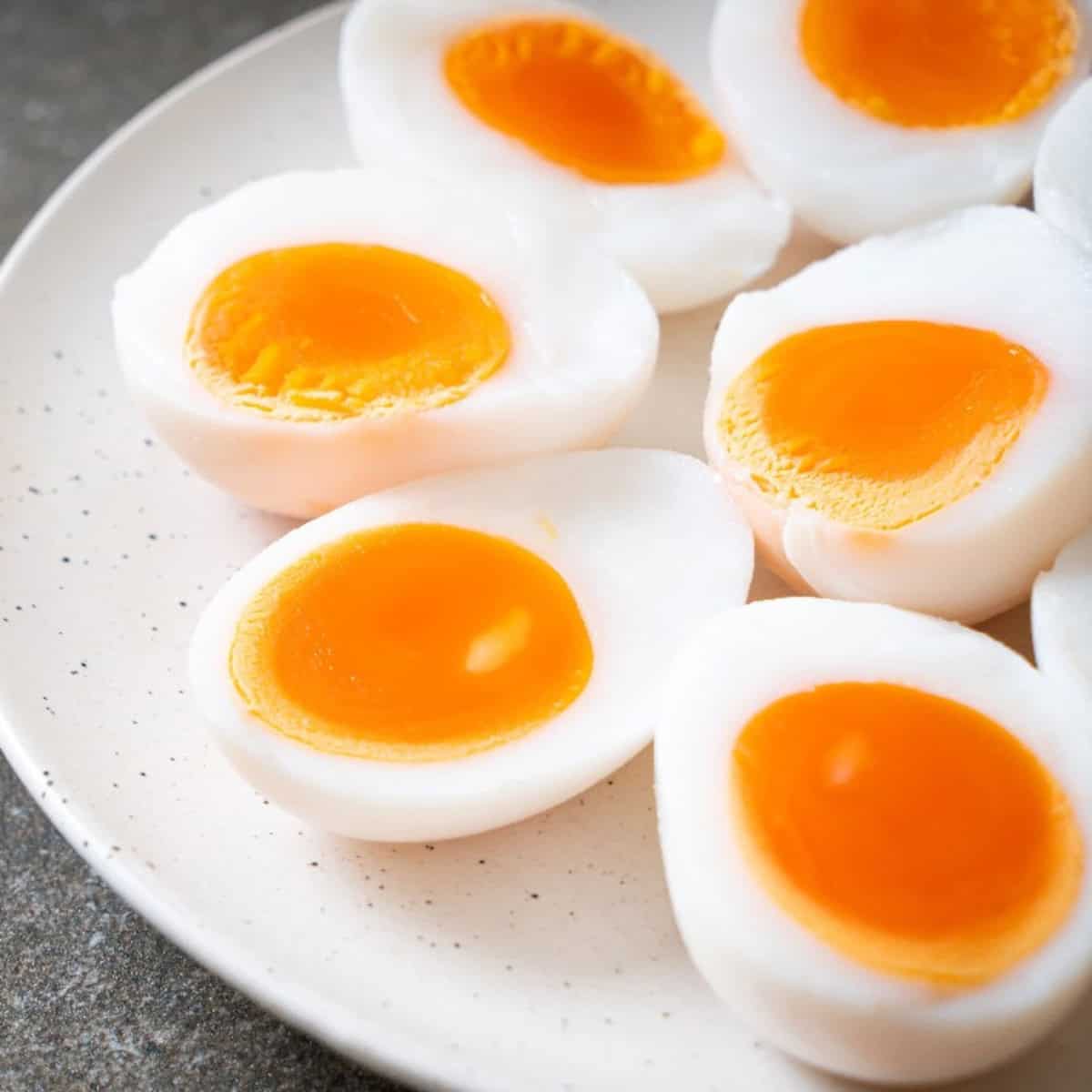 Sunny-side-up egg cooking in a skillet with a bright golden yolk and set egg white.