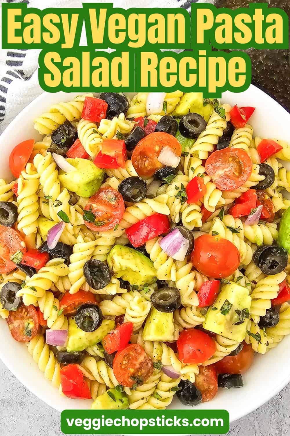 Vegan pasta salad featuring rotini pasta, avocado, cherry tomatoes, black olives, red bell pepper, and red onion with the text "Easy Vegan Pasta Salad Recipe.