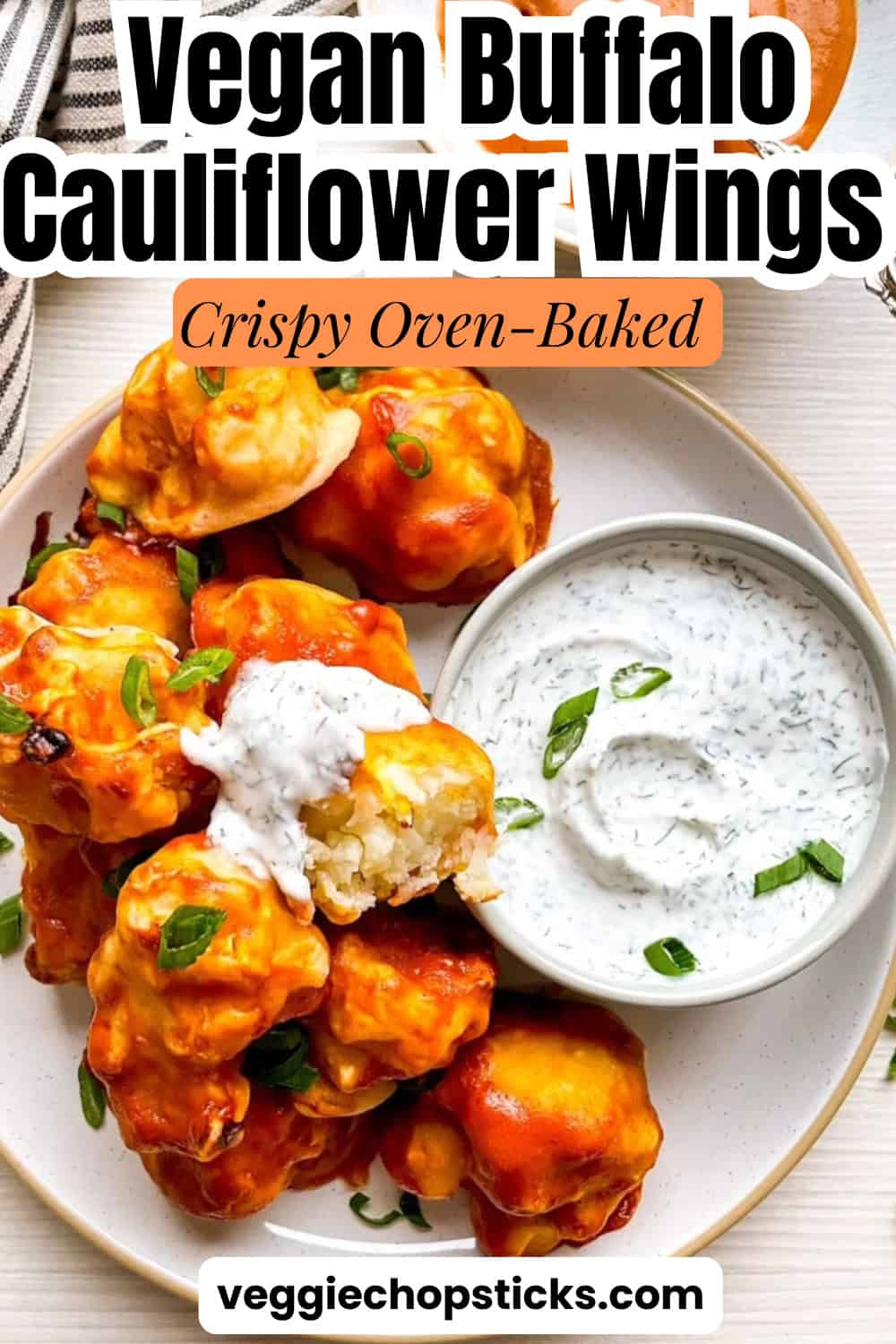 Vegan buffalo cauliflower wings with dipping sauce served on a plate for a game day appetizer.