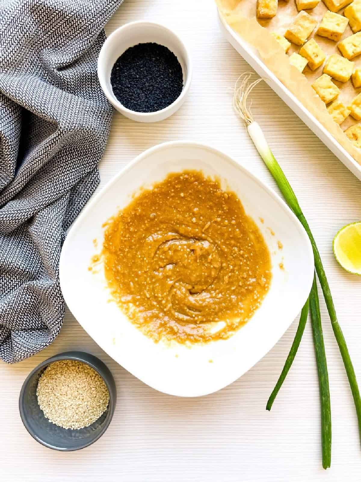 Creamy homemade peanut sauce mixed until smooth for sesame tofu.