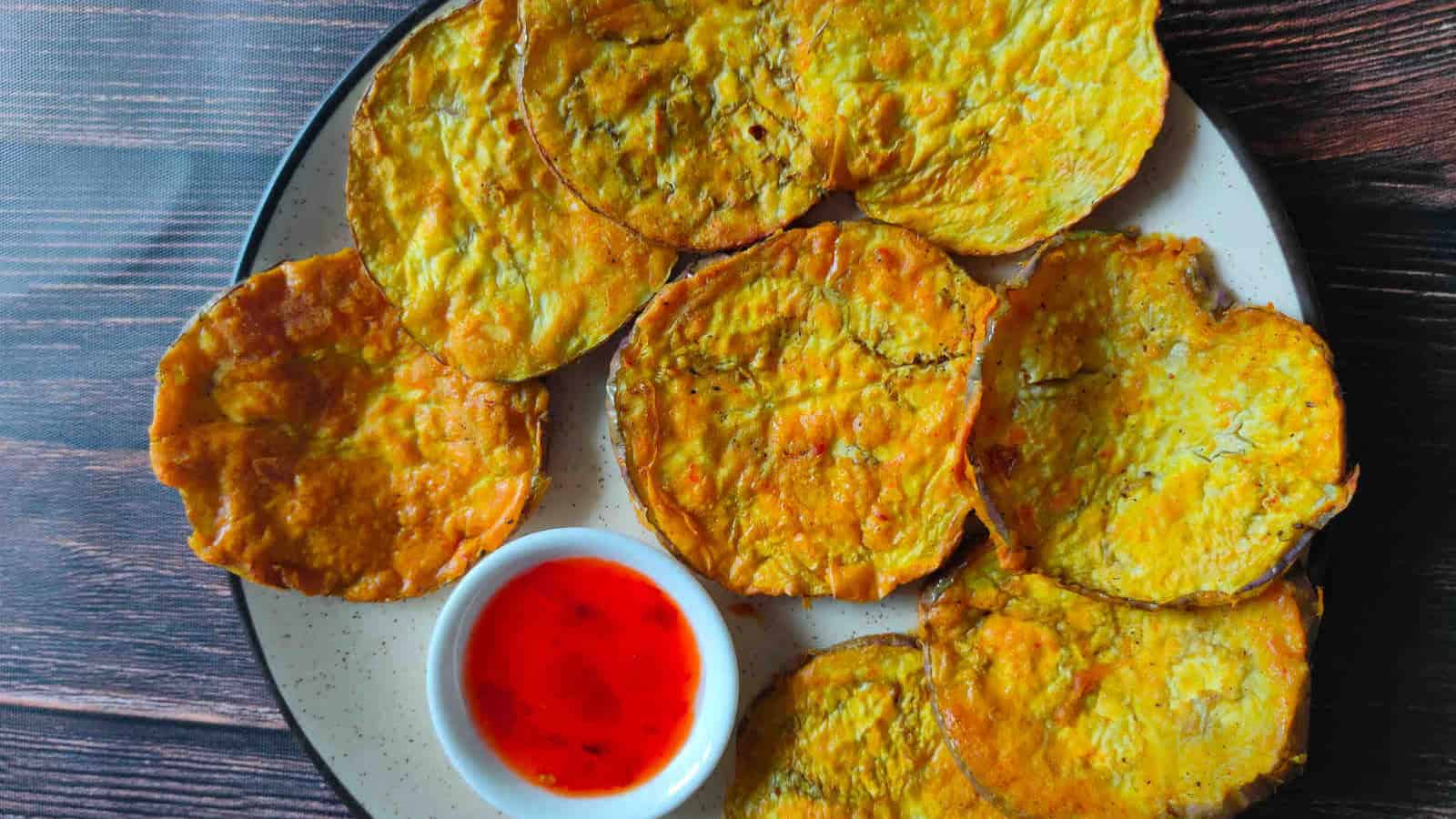 Crispy air fryer eggplant fries served with a dipping sauce.