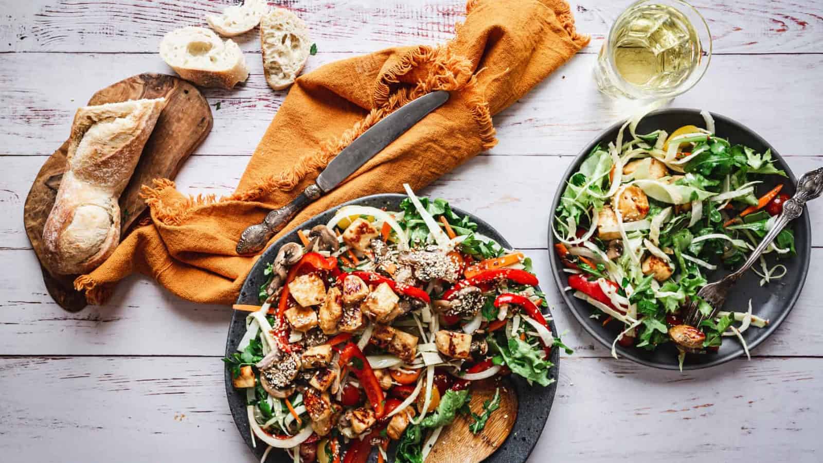 Fried halloumi served over a fresh salad with crisp vegetables.