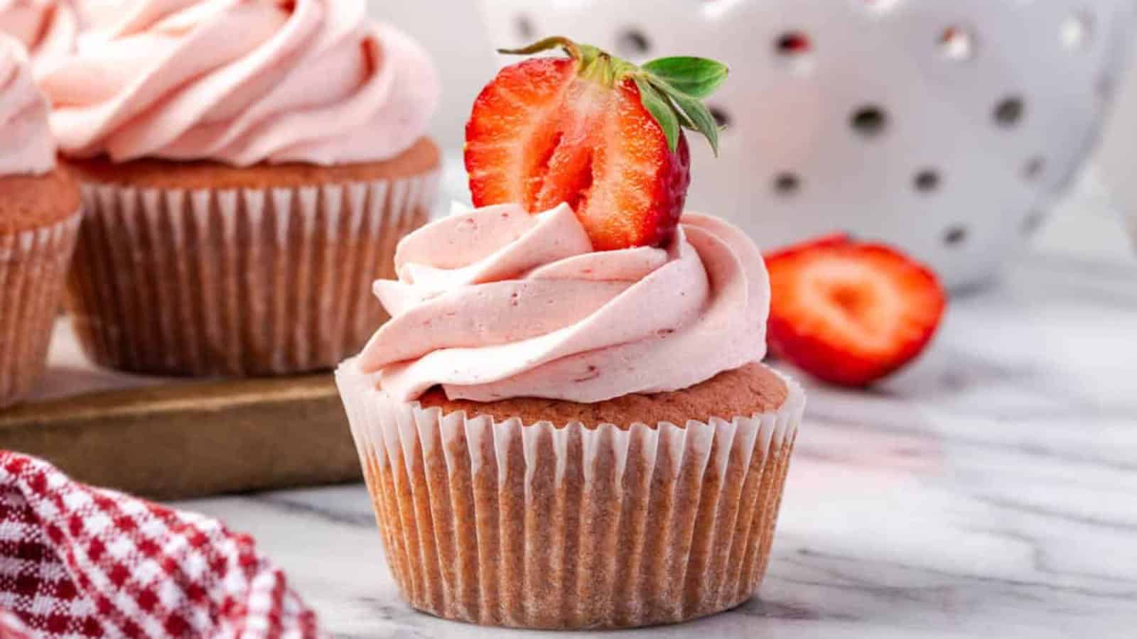 Soft gluten-free strawberry cupcakes topped with strawberry frosting.