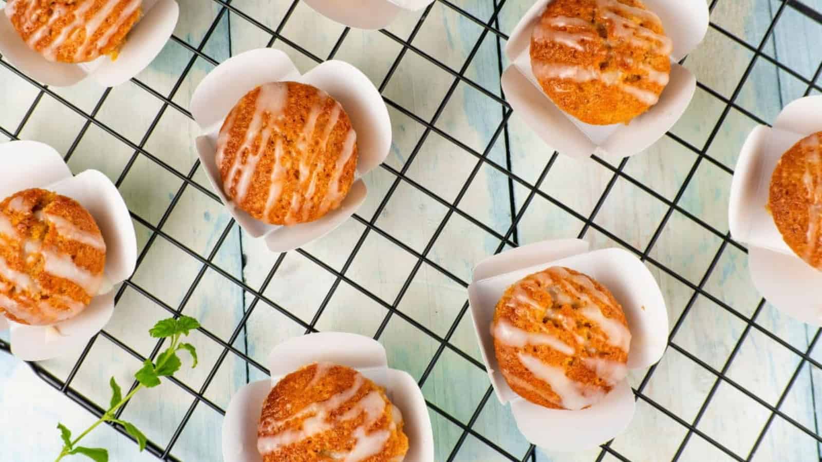 Gluten-free carrot cupcakes topped with dairy-free cream cheese frosting.