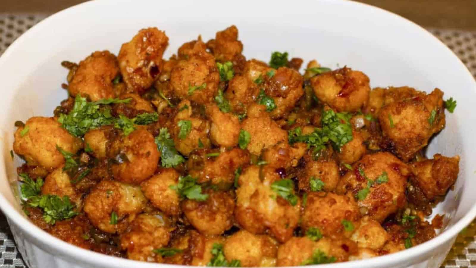 Crispy cauliflower coated in a savory and spicy Manchurian sauce.