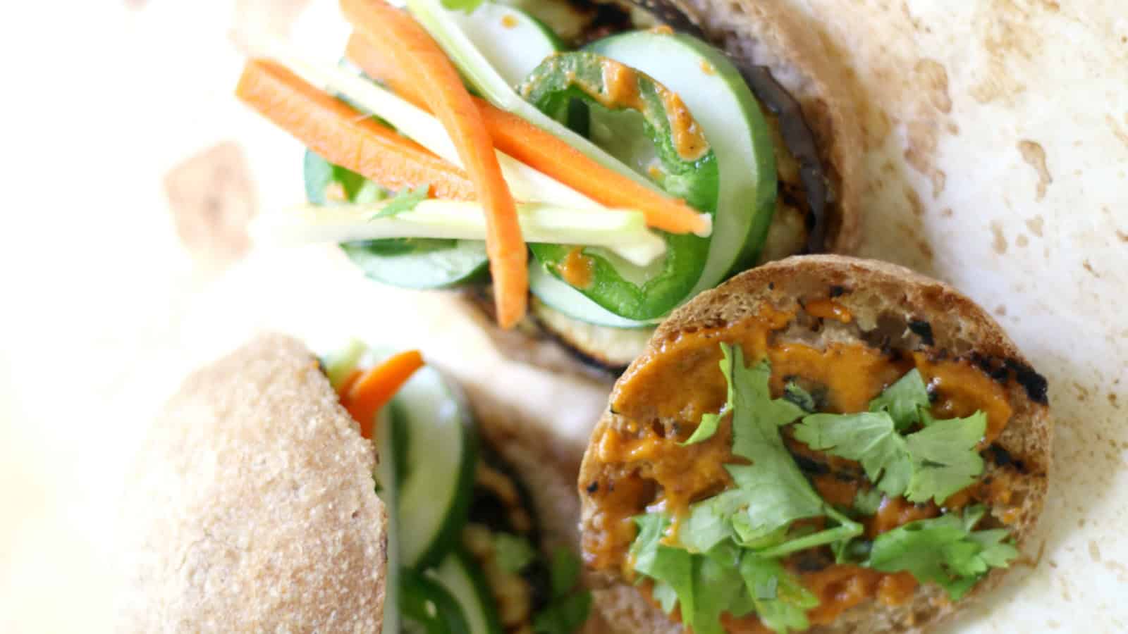 Grilled eggplant sliders topped with fresh banh mi-style vegetables.