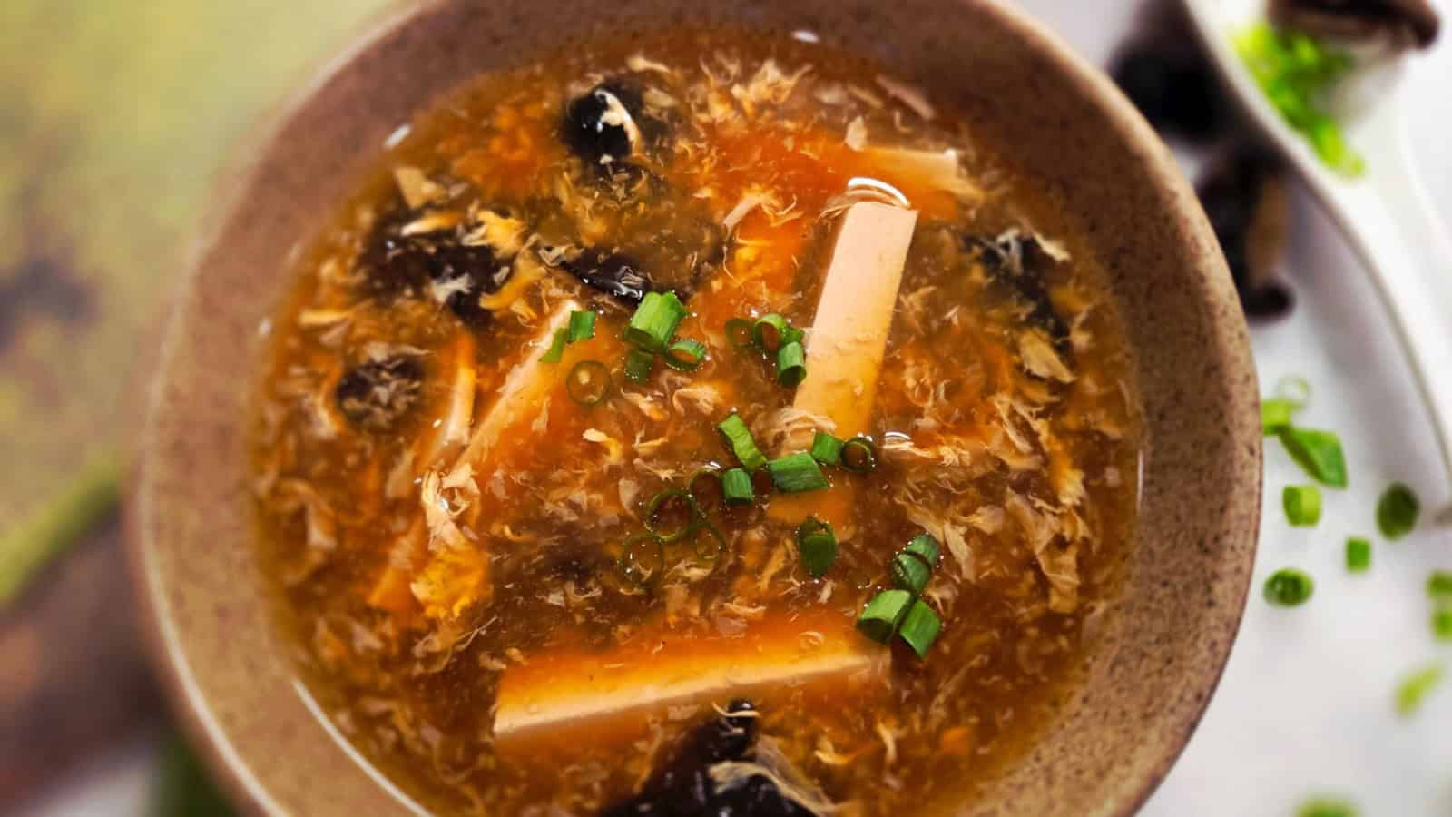 Hot and sour soup filled with vegetables in a savory broth.