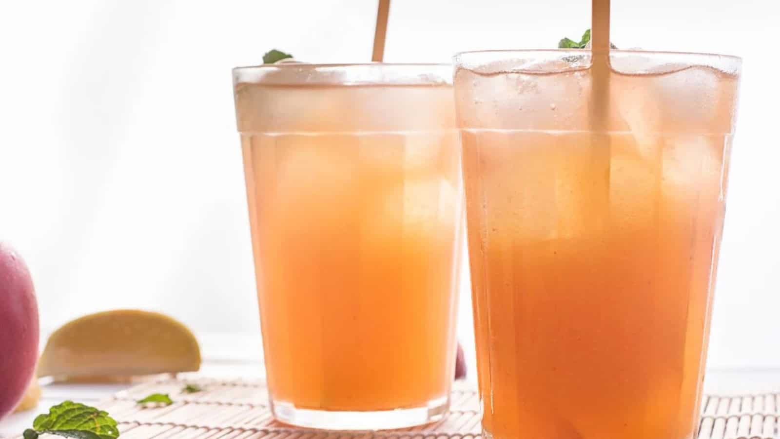 Peach black tea lemonade served over ice with lemon.