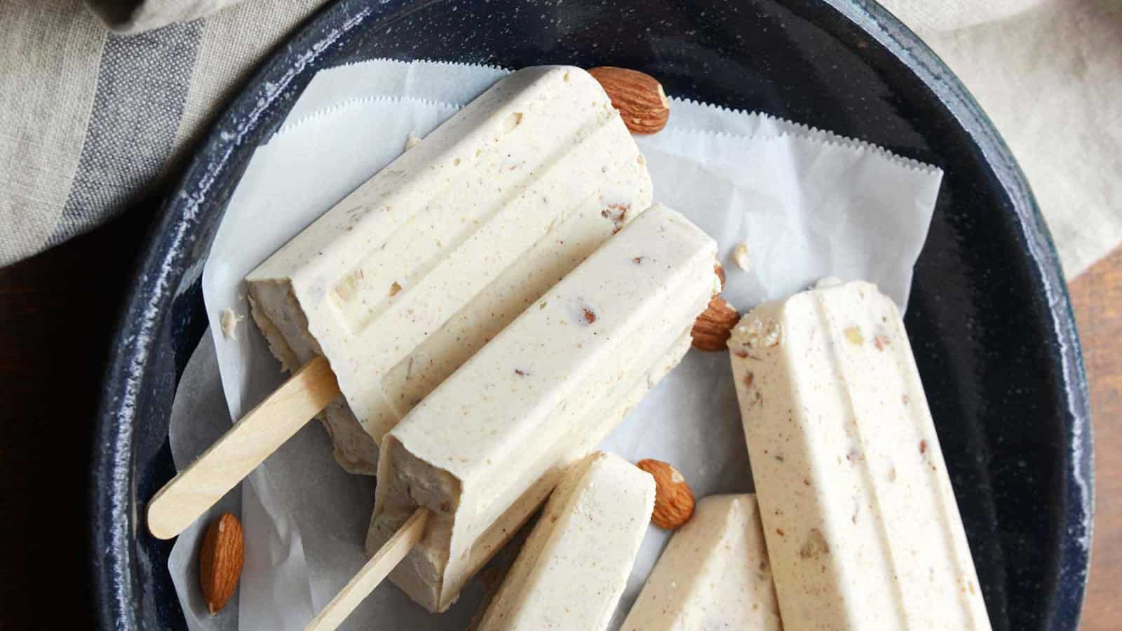 Creamy cheesecake popsicles flavored with dulce de leche, cinnamon, and toasted almonds.