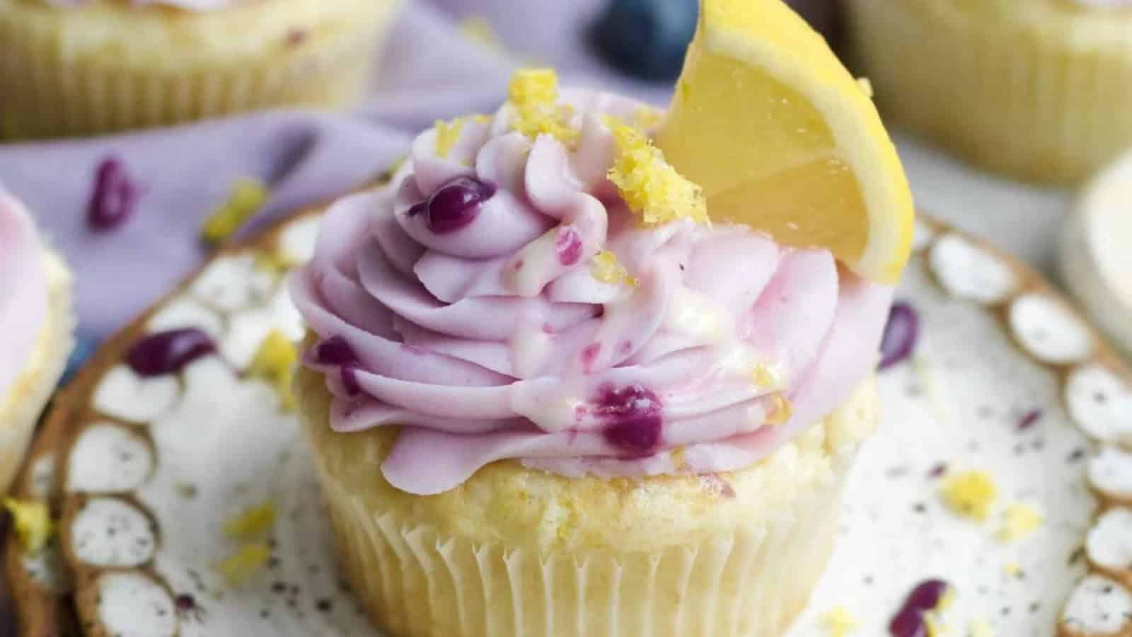 Lemon blueberry cupcakes topped with creamy frosting and fresh blueberries.