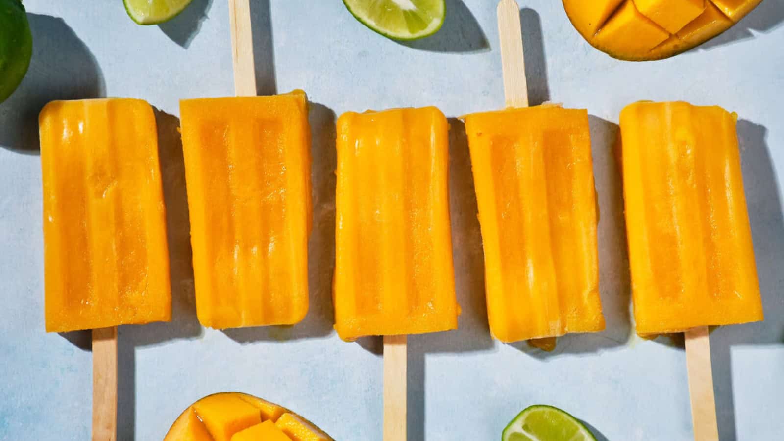 Creamy vegan mango popsicles with a tropical flavor.