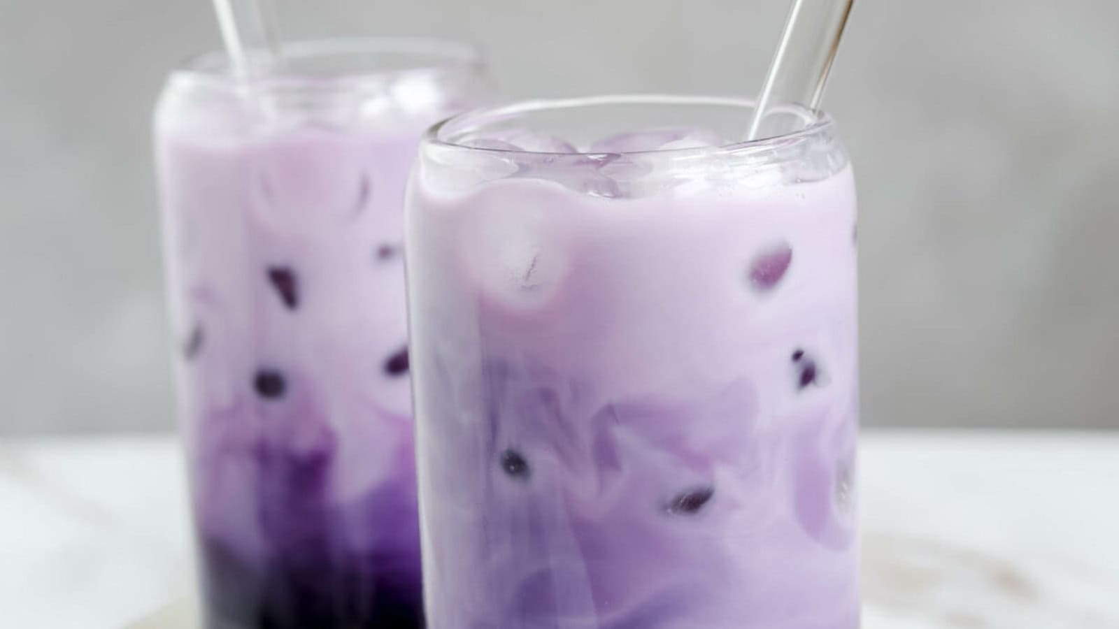Vibrant purple ube bubble tea with chewy tapioca pearls.