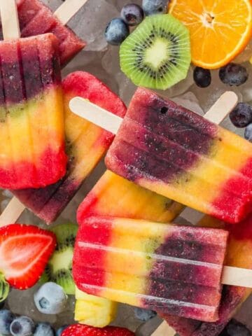 Colorful rainbow popsicles layered with vibrant fruit flavors.