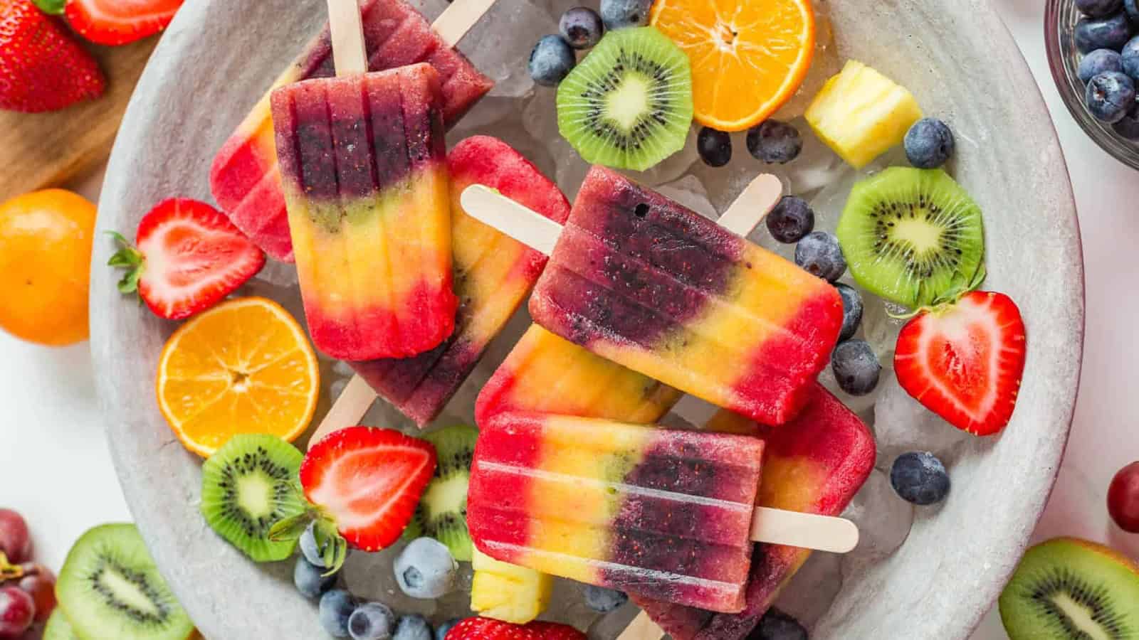 Colorful rainbow popsicles layered with vibrant fruit flavors.