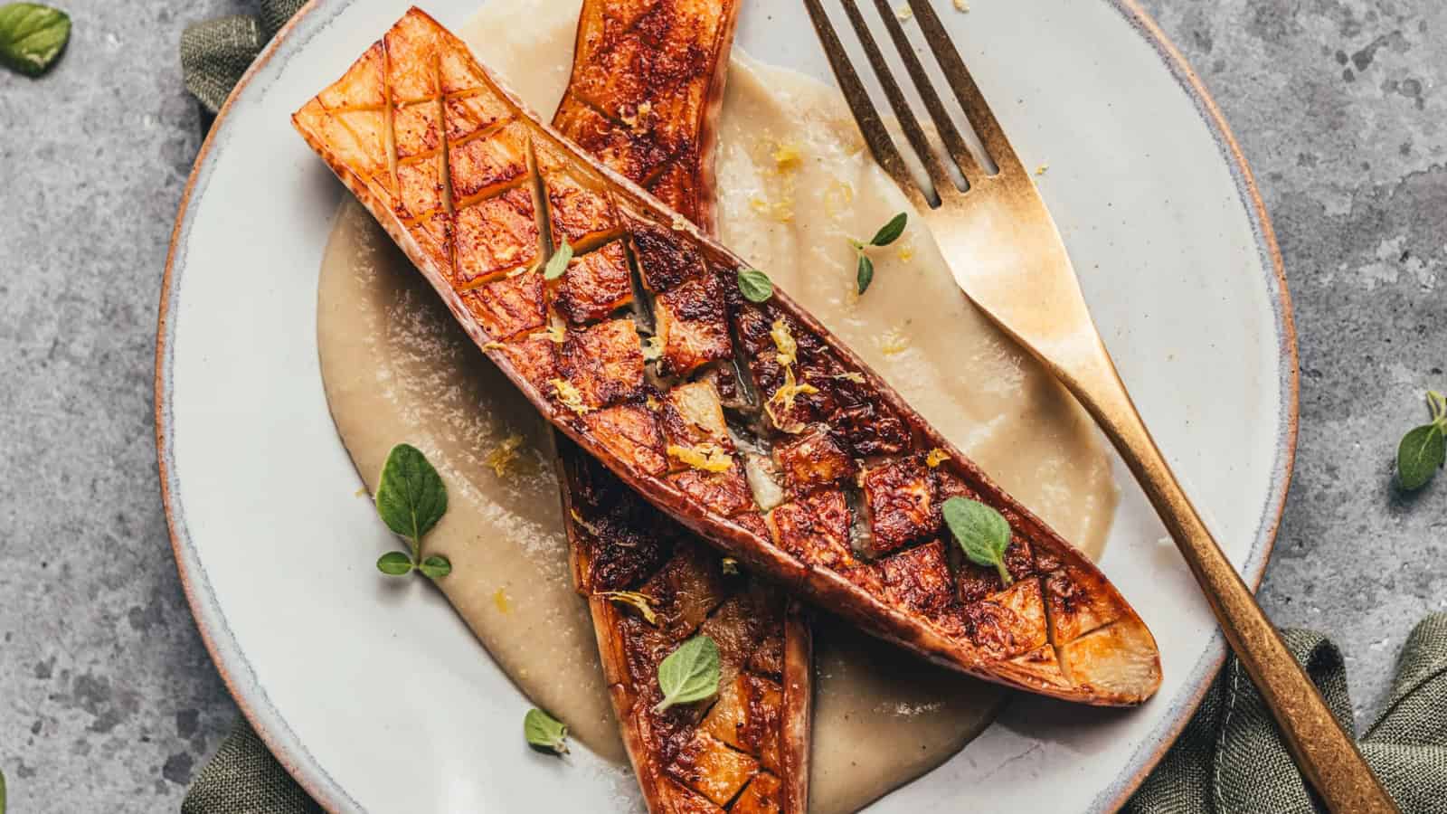 Seared eggplant served over creamy white bean pur&eacute;e with lemon and oregano.