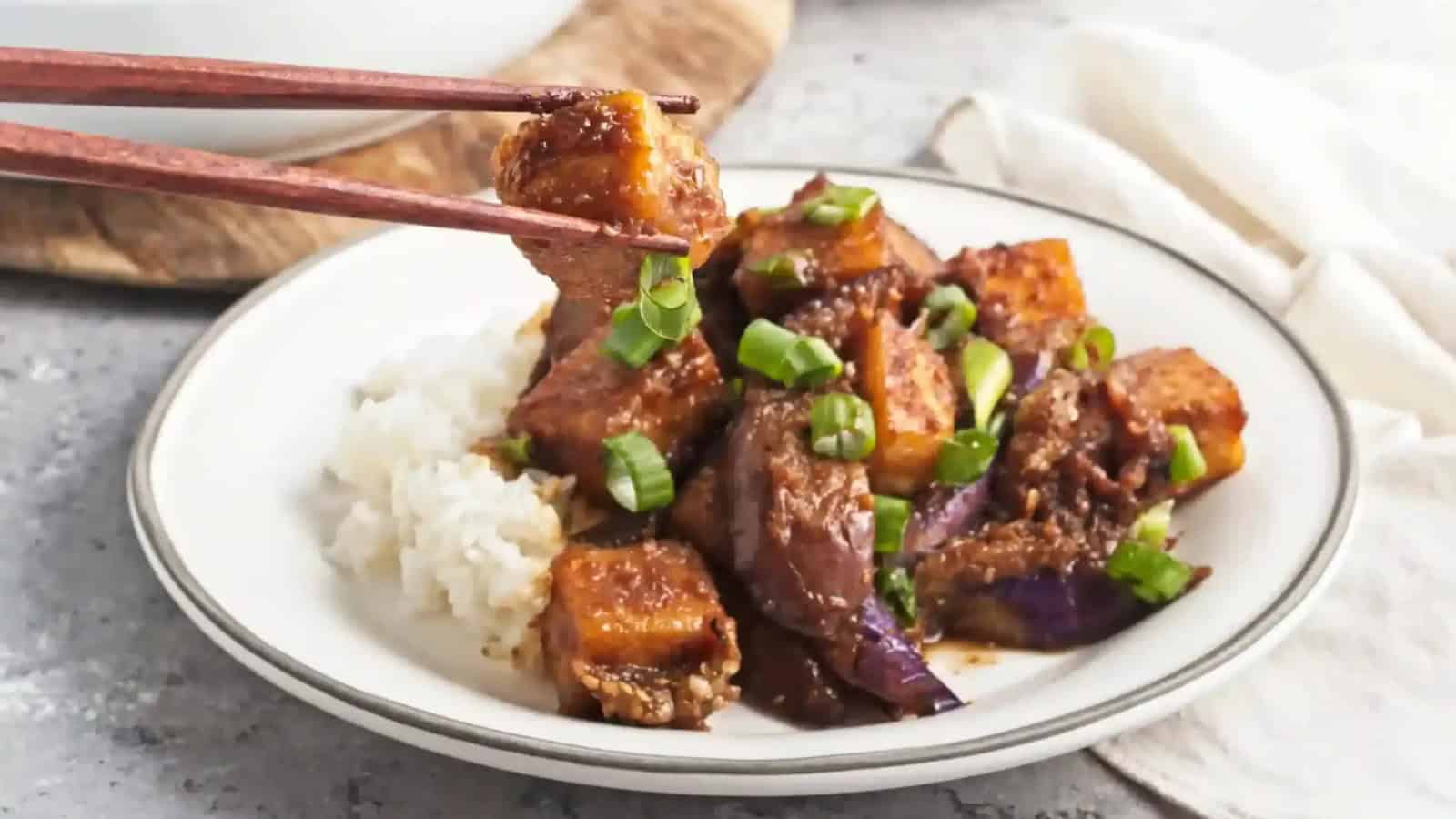 Sticky ginger-glazed eggplant and tofu served with fresh herbs.