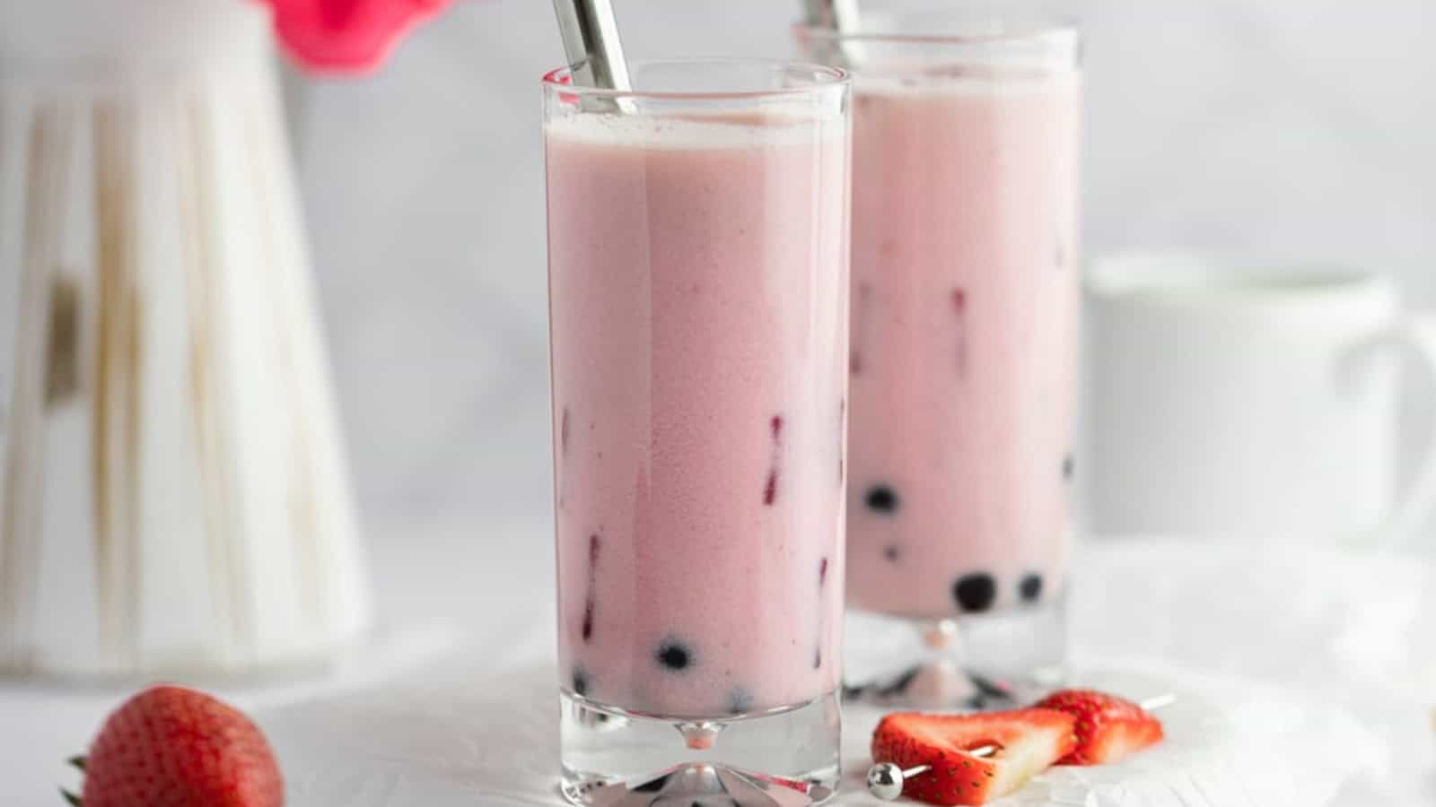 Creamy strawberry milk tea served with ice and boba pearls.