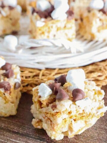Close-up of homemade S'mores Rice Krispie treats with Golden Grahams, chocolate chips, and mini marshmallows.
