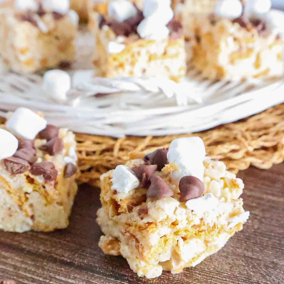 Close-up of homemade S'mores Rice Krispie treats with Golden Grahams, chocolate chips, and mini marshmallows.